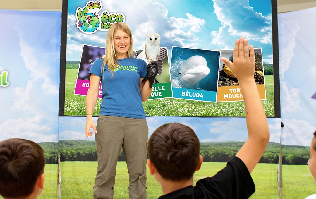 xxImage of Earth Ranger's associate holding an owl during a School Assembly Program