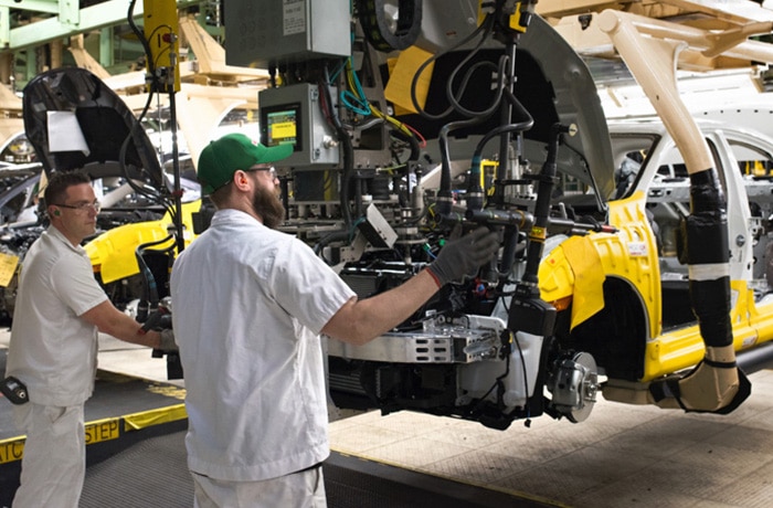 A Honda associate inspects a new vehicle.