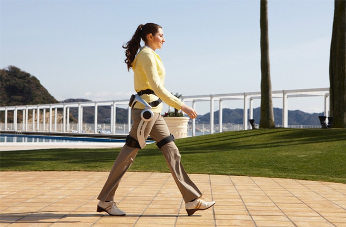 A woman walks using Honda’s Walking Assist Device.