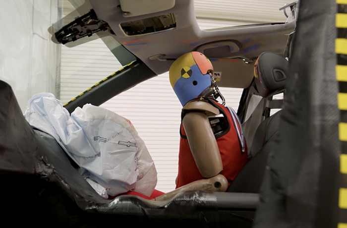 Image of crash test dummy sitting in vehicle.